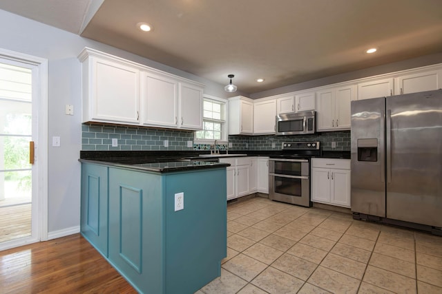 805 S Benson Pl, Nixa, MO 65714 - kitchen featuring stainless steel appliances, dark countertops, white cabinets, and recessed lighting