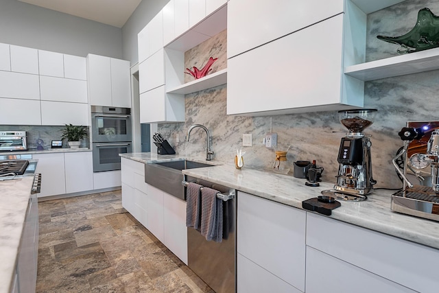 6323 Creeksedge Ct, Ozark, MO 65721 - kitchen featuring open shelves, modern cabinets, appliances with stainless steel finishes, decorative backsplash, and stone finish floors