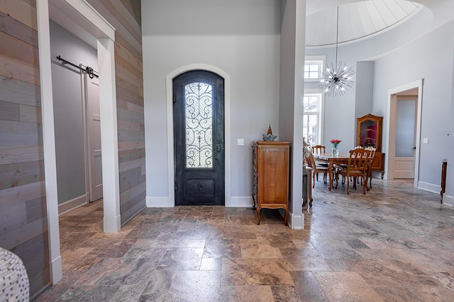 6323 Creeksedge Ct, Ozark, MO 65721 - entryway with stone tile flooring, a high ceiling, and wooden walls
