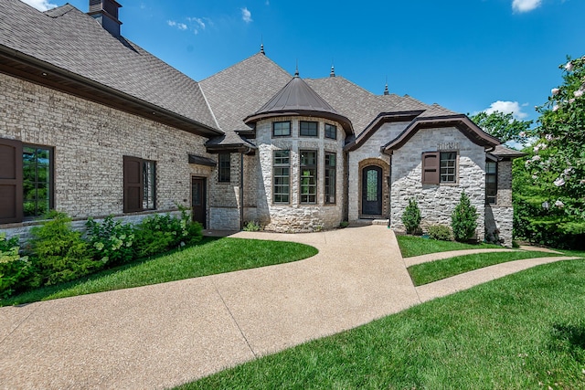 6323 Creeksedge Ct, Ozark, MO 65721 - french country style house with roof with shingles, a front lawn, stone siding, and a chimney