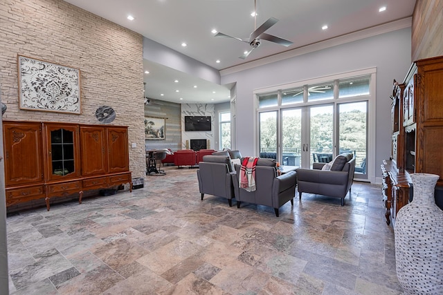 6323 Creeksedge Ct, Ozark, MO 65721 - living room featuring a ceiling fan, stone tile flooring, a high end fireplace, recessed lighting, and a towering ceiling