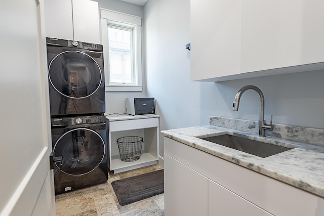 6323 Creeksedge Ct, Ozark, MO 65721 - laundry area featuring stacked washing machine and dryer, cabinet space, and light stone finish floors
