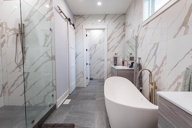 6323 Creeksedge Ct, Ozark, MO 65721 - bathroom with vanity, a soaking tub, walk in shower, tile walls, and marble finish floors