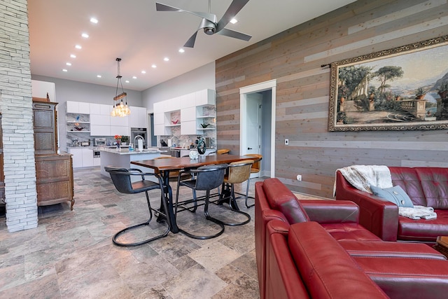 6323 Creeksedge Ct, Ozark, MO 65721 - dining space with wood walls, ceiling fan, light stone finish floors, and recessed lighting
