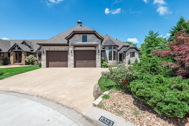 6323 Creeksedge Ct, Ozark, MO 65721 - french provincial home featuring stone siding, driveway, and an attached garage