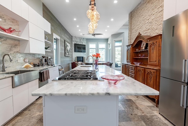 6323 Creeksedge Ct, Ozark, MO 65721 - kitchen featuring appliances with stainless steel finishes, open shelves, modern cabinets, stone tile flooring, and white cabinetry