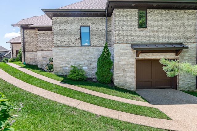 6323 Creeksedge Ct, Ozark, MO 65721 - view of home's exterior with stone siding, an attached garage, and concrete driveway