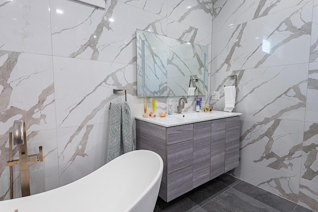6323 Creeksedge Ct, Ozark, MO 65721 - bathroom featuring tile walls, a freestanding tub, vanity, marble tiled flooring, and stone wall
