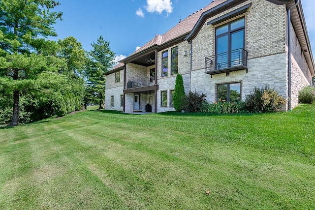 6323 Creeksedge Ct, Ozark, MO 65721 - rear view of property with a balcony, stone siding, a lawn, and a ceiling fan