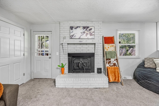 2515 S Newton Ave, Springfield, MO 65807 - living room with carpet, plenty of natural light, a fireplace, and a textured ceiling