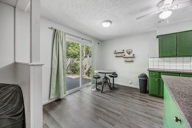 2515 S Newton Ave, Springfield, MO 65807 - dining space with wood finished floors, a ceiling fan, and a textured ceiling