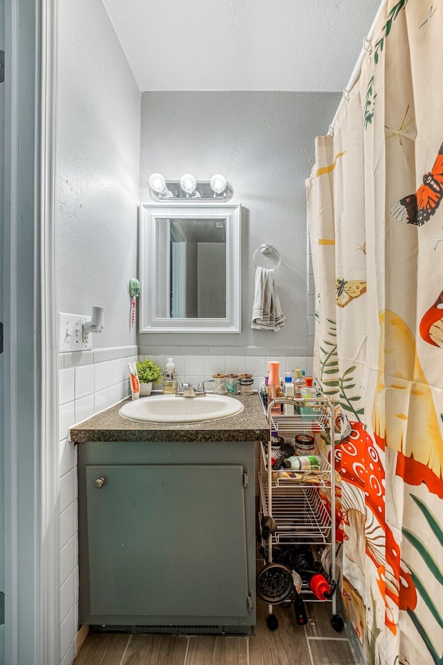 2515 S Newton Ave, Springfield, MO 65807 - bathroom with vanity, wood finished floors, and tile walls