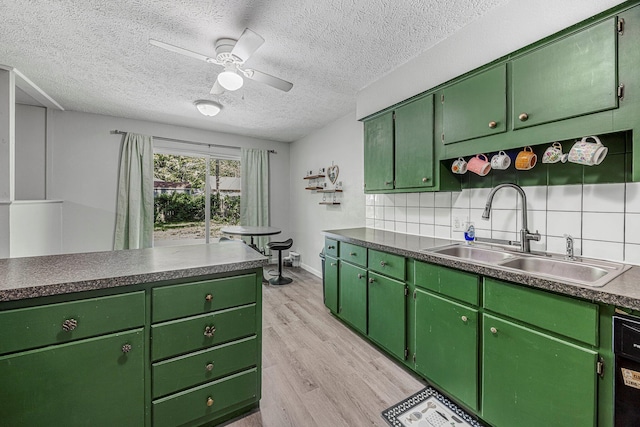 2515 S Newton Ave, Springfield, MO 65807 - kitchen with light wood-style flooring, a ceiling fan, backsplash, a textured ceiling, and dishwashing machine