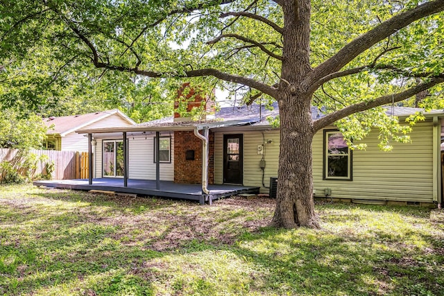 2515 S Newton Ave, Springfield, MO 65807 - rear view of house with a chimney and a wooden deck