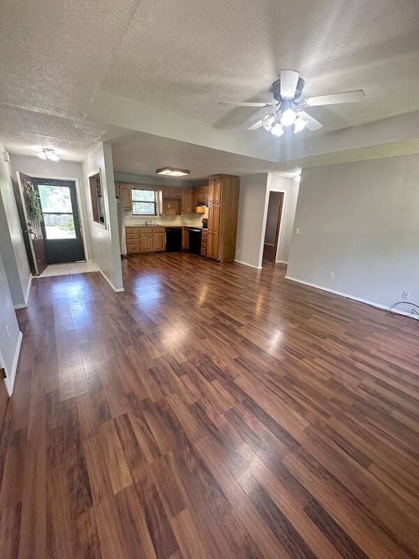 2201 S 18th Ave, Ozark, MO 65721 - unfurnished living room featuring a textured ceiling, dark wood-style flooring, and a ceiling fan