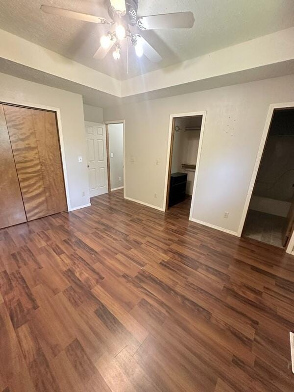 2201 S 18th Ave, Ozark, MO 65721 - unfurnished bedroom with dark wood finished floors, ensuite bath, and a ceiling fan