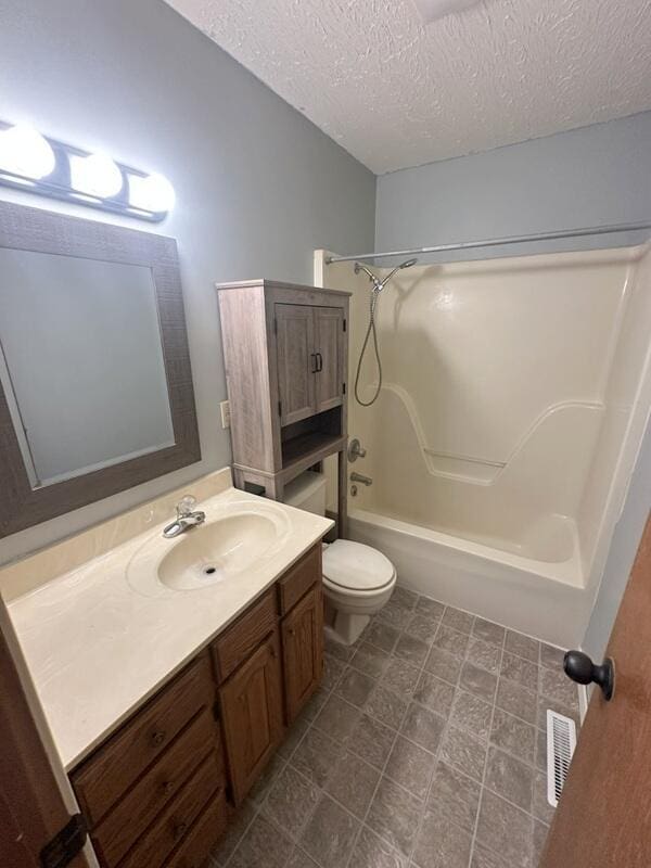 2201 S 18th Ave, Ozark, MO 65721 - full bathroom with vanity, tub / shower combination, and a textured ceiling