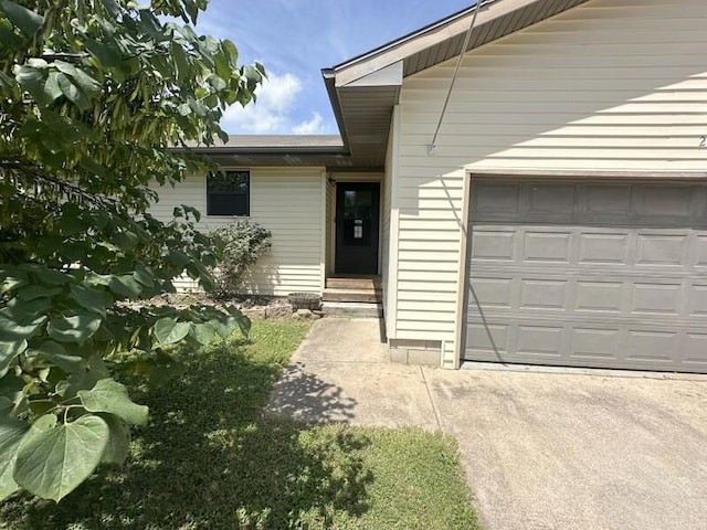 2201 S 18th Ave, Ozark, MO 65721 - view of exterior entry with an attached garage