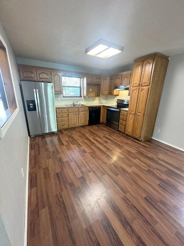 2201 S 18th Ave, Ozark, MO 65721 - kitchen featuring black appliances, dark wood-type flooring, light countertops, a textured ceiling, and under cabinet range hood