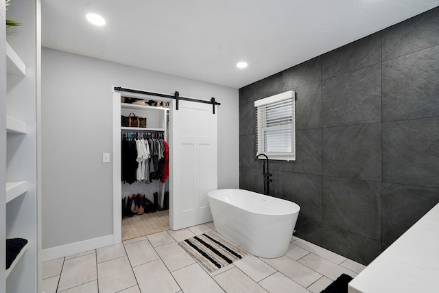 12163 State Highway Tt, Republic, MO 65738 - full bath with a freestanding bath, a walk in closet, recessed lighting, and tile patterned floors