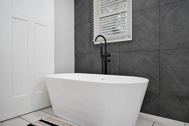 12163 State Highway Tt, Republic, MO 65738 - full bath featuring tile patterned floors, a freestanding bath, and tile walls
