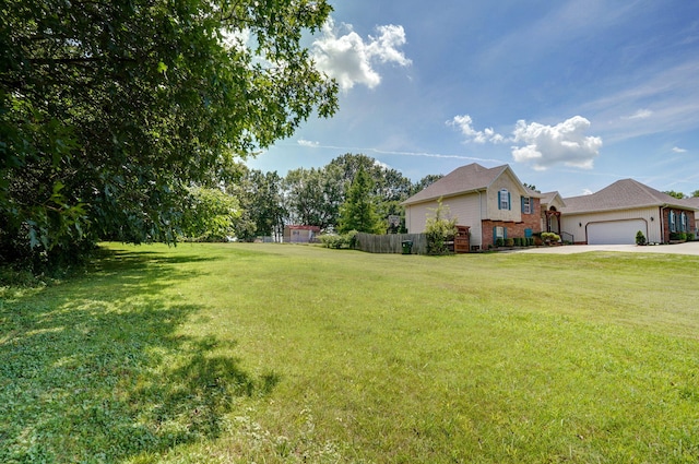 823 Mcvey St, Mount Vernon, MO 65712 - view of green lawn featuring a garage and driveway