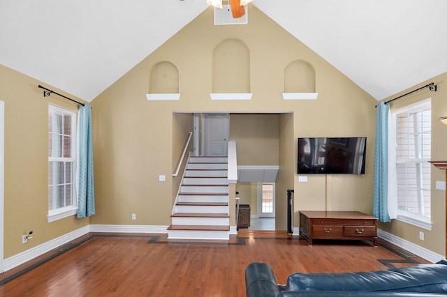 823 Mcvey St, Mount Vernon, MO 65712 - living room featuring wood finished floors, stairway, plenty of natural light, high vaulted ceiling, and a ceiling fan
