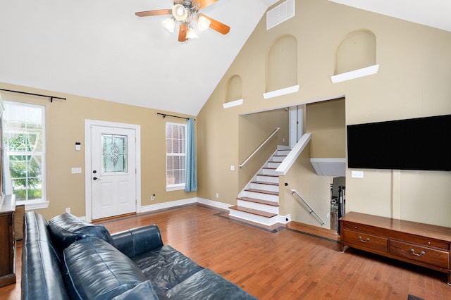 823 Mcvey St, Mount Vernon, MO 65712 - living area featuring wood finished floors, ceiling fan, high vaulted ceiling, and stairs