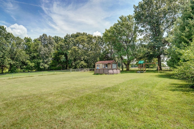 823 Mcvey St, Mount Vernon, MO 65712 - fenced backyard with a storage shed and a playground