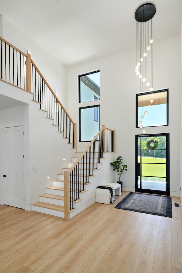 104 Walnut Hill Ln, Ozark, MO 65721 - foyer entrance featuring a towering ceiling, wood finished floors, and stairs