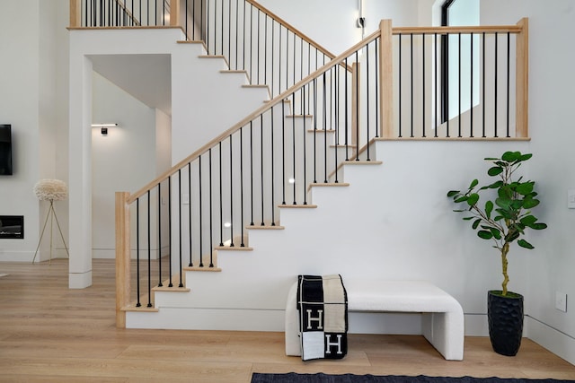 104 Walnut Hill Ln, Ozark, MO 65721 - staircase with wood finished floors and a towering ceiling