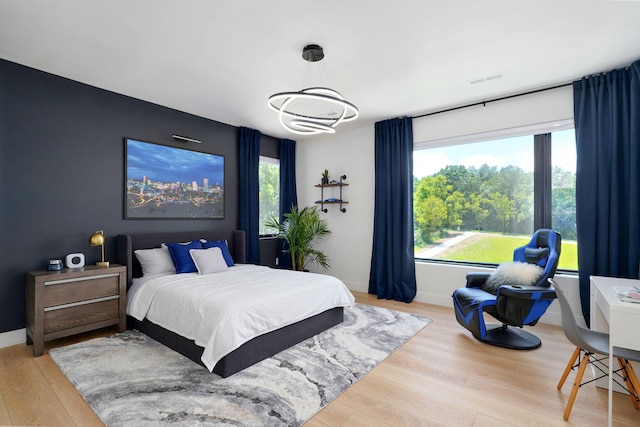 104 Walnut Hill Ln, Ozark, MO 65721 - bedroom featuring wood finished floors and a chandelier
