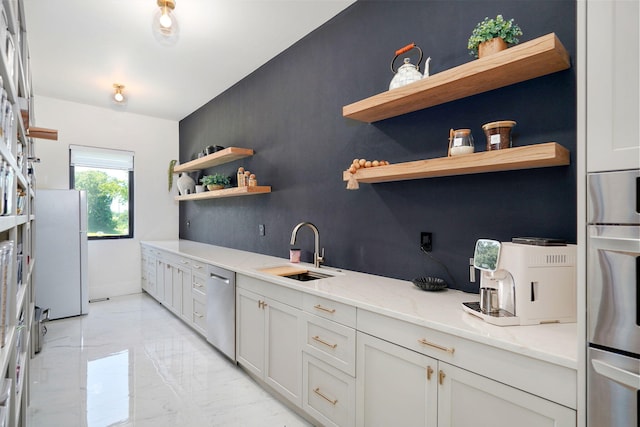 104 Walnut Hill Ln, Ozark, MO 65721 - kitchen with open shelves, light marble finish flooring, appliances with stainless steel finishes, light stone counters, and white cabinets
