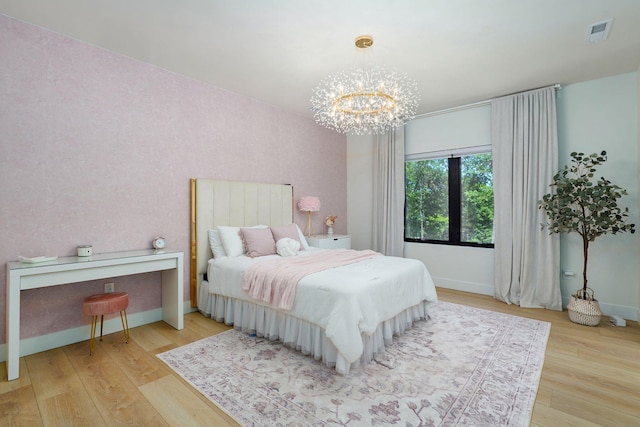 104 Walnut Hill Ln, Ozark, MO 65721 - bedroom with a chandelier and wood finished floors