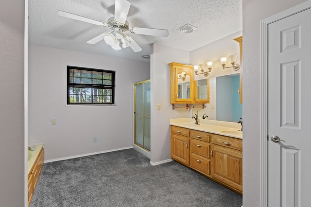 8756 W Farm Rd Unit 124, Springfield, MO 65802 - bathroom featuring a stall shower, double vanity, a textured ceiling, carpet, and a ceiling fan