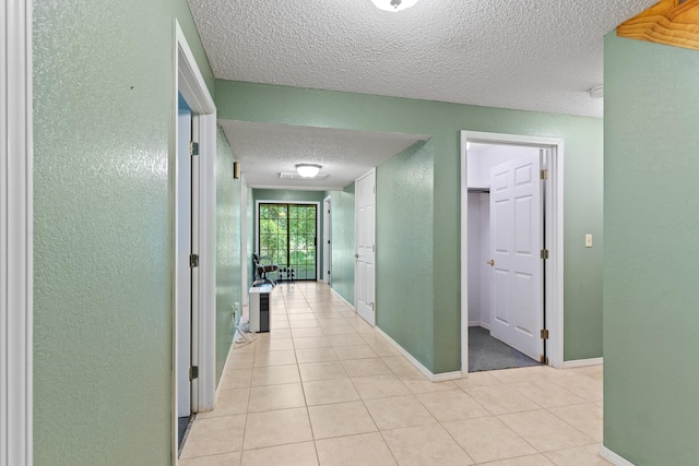 8756 W Farm Rd Unit 124, Springfield, MO 65802 - corridor with a textured ceiling, light tile patterned floors, and a textured wall