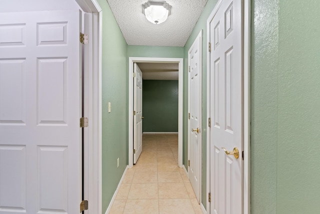 8756 W Farm Rd Unit 124, Springfield, MO 65802 - corridor featuring light tile patterned flooring, a textured ceiling, and a textured wall