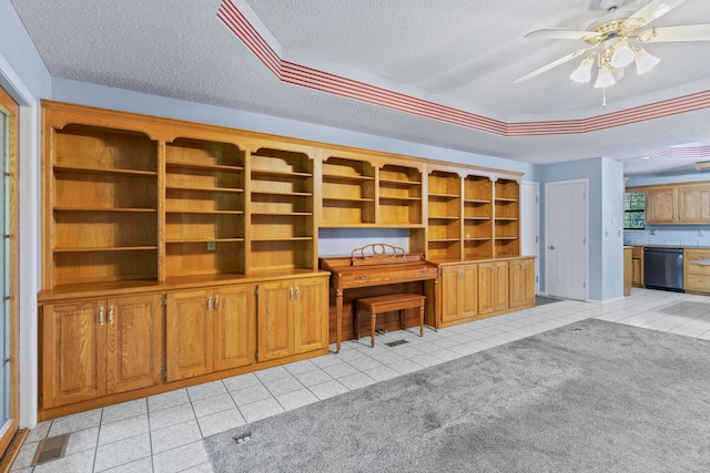 8756 W Farm Rd Unit 124, Springfield, MO 65802 - unfurnished living room with a tray ceiling, a textured ceiling, light tile patterned floors, and ceiling fan
