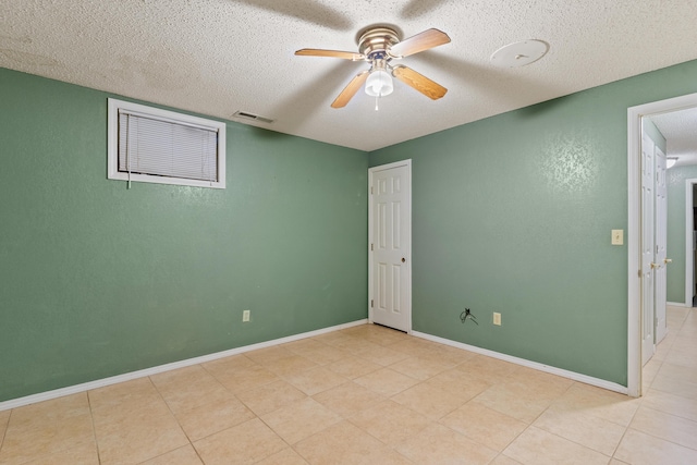 8756 W Farm Rd Unit 124, Springfield, MO 65802 - unfurnished bedroom with a textured ceiling, light tile patterned floors, ceiling fan, and a textured wall