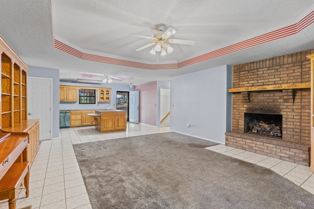 8756 W Farm Rd Unit 124, Springfield, MO 65802 - unfurnished living room with a raised ceiling, ceiling fan, a textured ceiling, light tile patterned flooring, and a brick fireplace