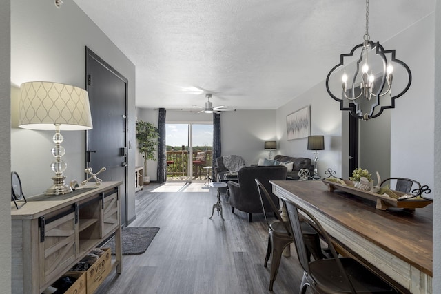 2915 Vineyards Pkwy Unit 6, Branson, MO 65616 - dining space with wood finished floors, ceiling fan, a chandelier, and a textured ceiling