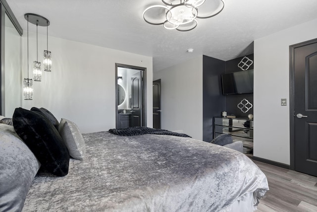 2915 Vineyards Pkwy Unit 6, Branson, MO 65616 - bedroom with a chandelier and wood finished floors