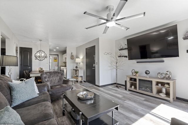 2915 Vineyards Pkwy Unit 6, Branson, MO 65616 - living area with a chandelier, light wood-style floors, and a ceiling fan
