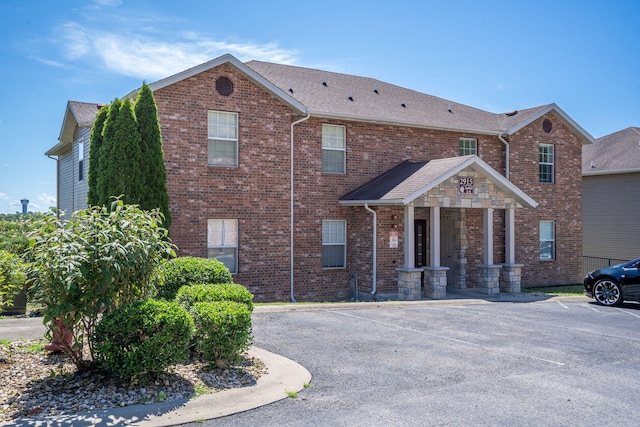 2915 Vineyards Pkwy Unit 6, Branson, MO 65616 - view of front of house with uncovered parking, brick siding, and roof with shingles