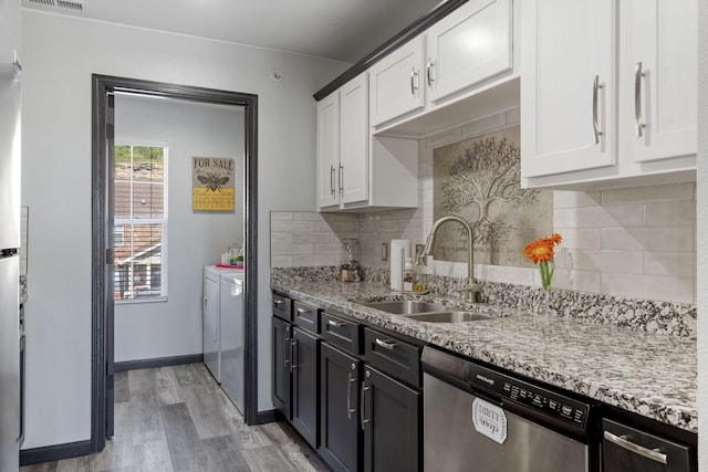 2915 Vineyards Pkwy Unit 6, Branson, MO 65616 - kitchen featuring dishwasher, separate washer and dryer, light wood finished floors, light stone counters, and white cabinetry