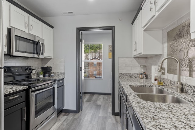 2915 Vineyards Pkwy Unit 6, Branson, MO 65616 - kitchen with stainless steel appliances, white cabinets, and light stone countertops