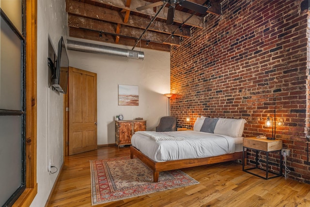 509 W Olive St Unit 206, Springfield, MO 65806 - bedroom featuring brick wall, a high ceiling, and light wood finished floors