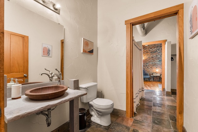 509 W Olive St Unit 206, Springfield, MO 65806 - bathroom featuring stone tile flooring and toilet