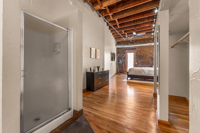 509 W Olive St Unit 206, Springfield, MO 65806 - bedroom featuring hardwood / wood-style flooring and brick wall