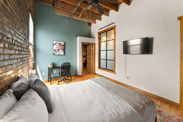 509 W Olive St Unit 206, Springfield, MO 65806 - bedroom with beam ceiling, wood finished floors, and a barn door
